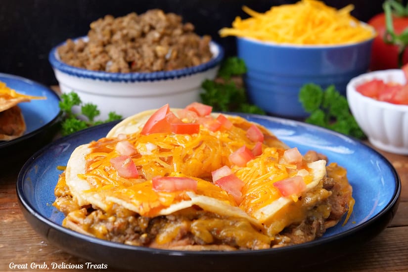 A horizonal photo of a blue round plate with a copycat Taco Bell Mexican Pizza on it.