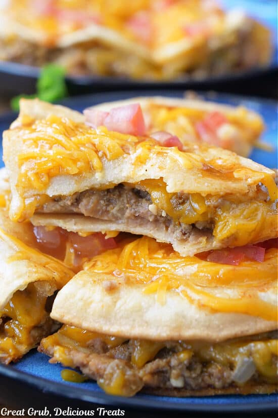 A bite taken out of a piece of homemade copycat Mexican pizza from Taco Bell.