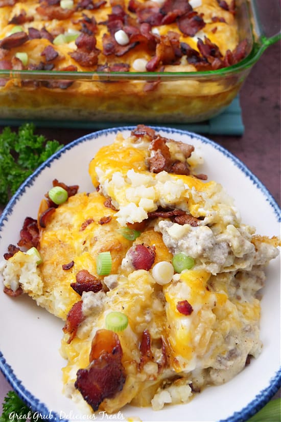 An overhead shot of a serving of breakfast casserole in a white bowl with blue trim.
