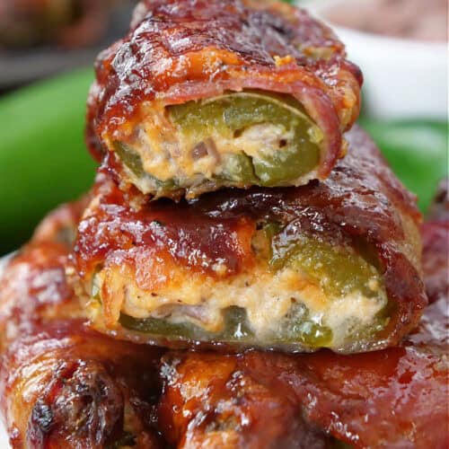 A stack of some Texas Twinkies which are stuffed jalapenos wrapped in bacon and baked, then covered in BBQ sauce.