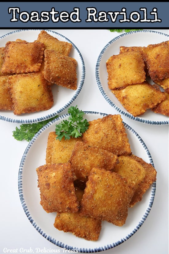 Three white plates with blue trim with toasted raviolis on them.