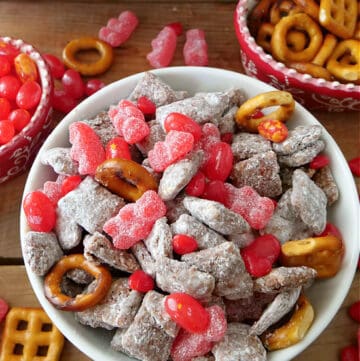 A white bowl filled with Valentine puppy chow snack mix.