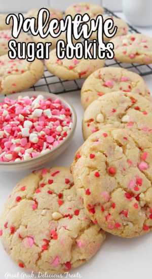 Valentine Sugar Cookies are a delicious sugar cookie recipe to make for Valentine’s Day, Valentine’s Day themed parties, potlucks, or an afternoon snack. A white surface with Valentine's Day sugar cookies on it.