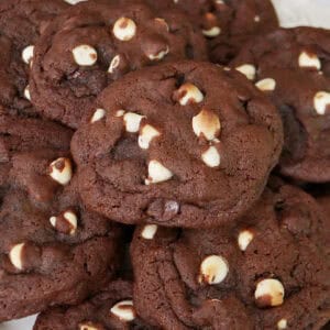 A stack of white chocolate chip cookies piled on top of each other.