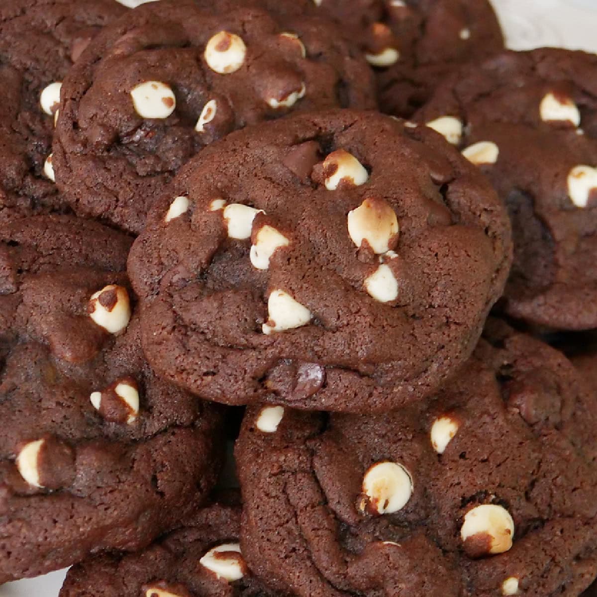 A stack of white chocolate chip cookies piled on top of each other.